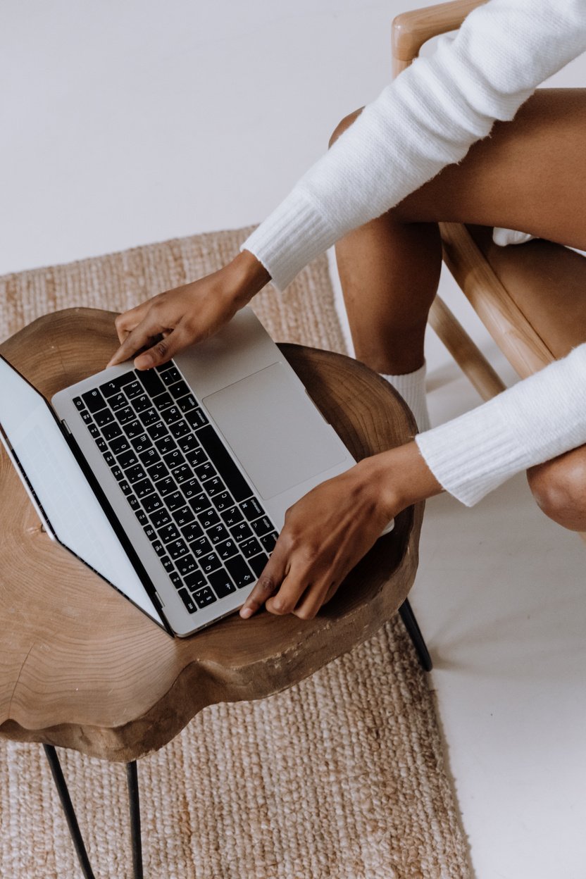 Person in White Long Sleeve Shirt Using Macbook Pro